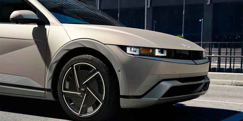 electric car front corner with alloy wheel closeup
