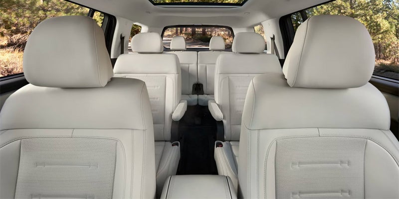 Spacious interior of SUV with white seating and third-row configuration